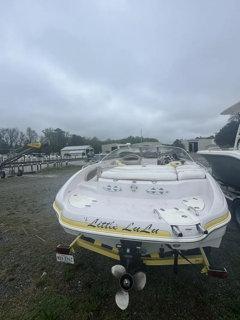 Slide: The Image of 2006 Tahoe 215 boat named "Little LuLa" parked outdoors on a cloudy day. - 1