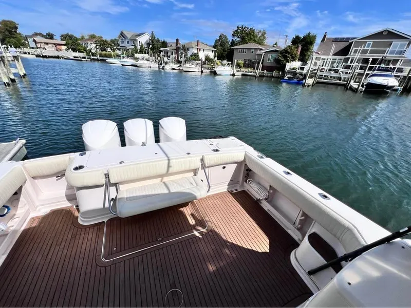 Slide: The Image of 2005 Grady-White Express 360 boat with spacious deck, docked in a serene marina. - 18