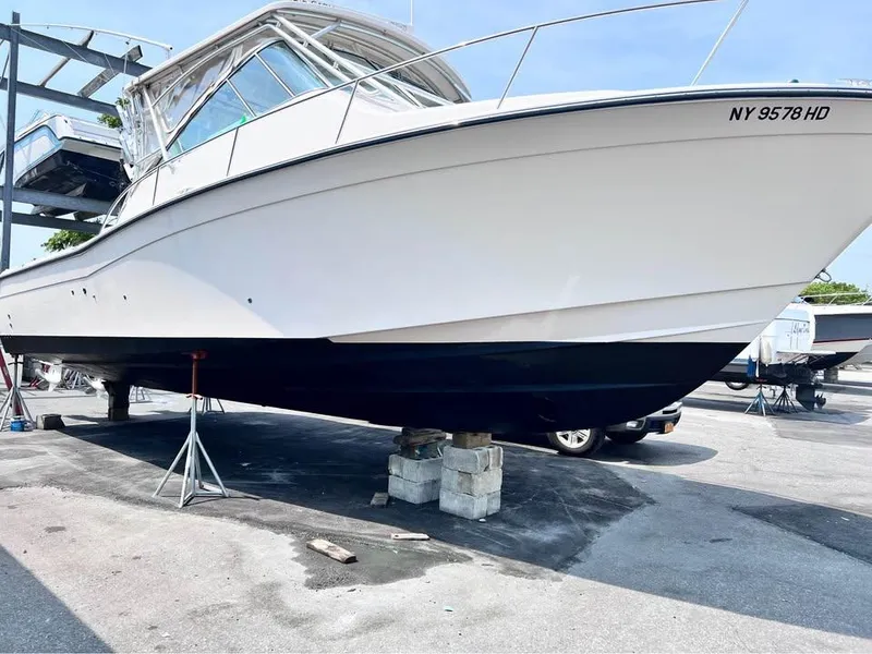 Slide: The Image of 2005 Grady-White Express 360 boat on dry dock, white hull, black bottom, NY registration. - 2