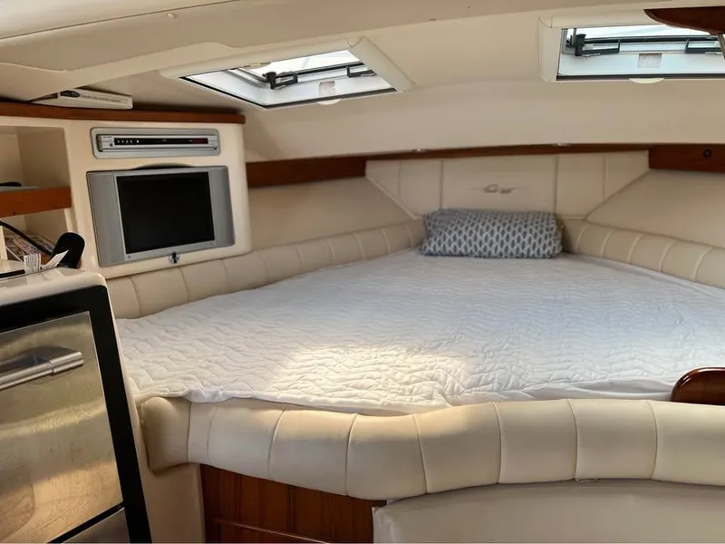 Slide: The Image of 2005 Grady-White Express 360 cabin interior with bed, TV, and skylights. - 7