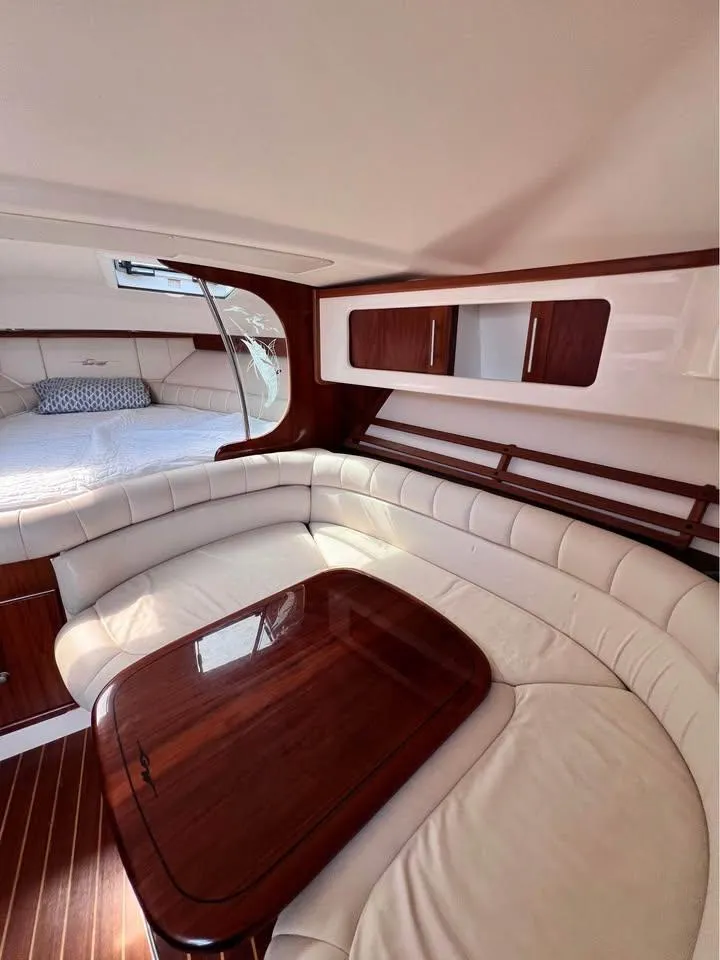 Slide: The Image of 2005 Grady-White Express 360 cabin interior with elegant seating and wooden table. - 9