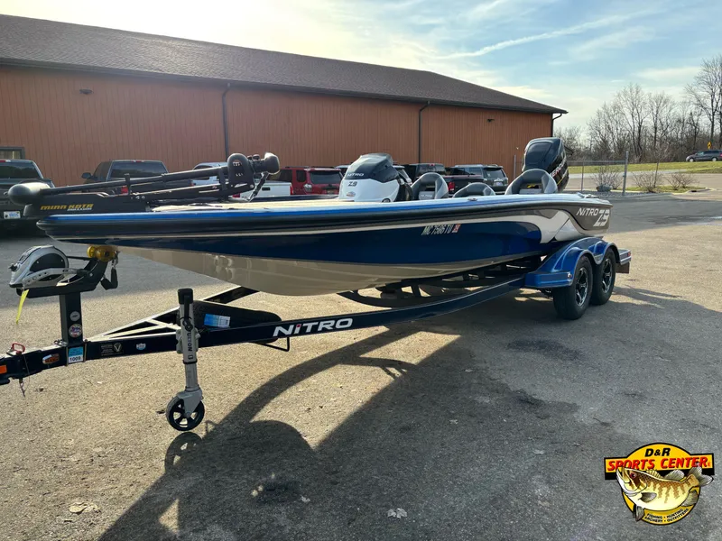 Slide: The Image of 2015 Nitro Z-9 boat on trailer, parked outdoors near a building. - 3