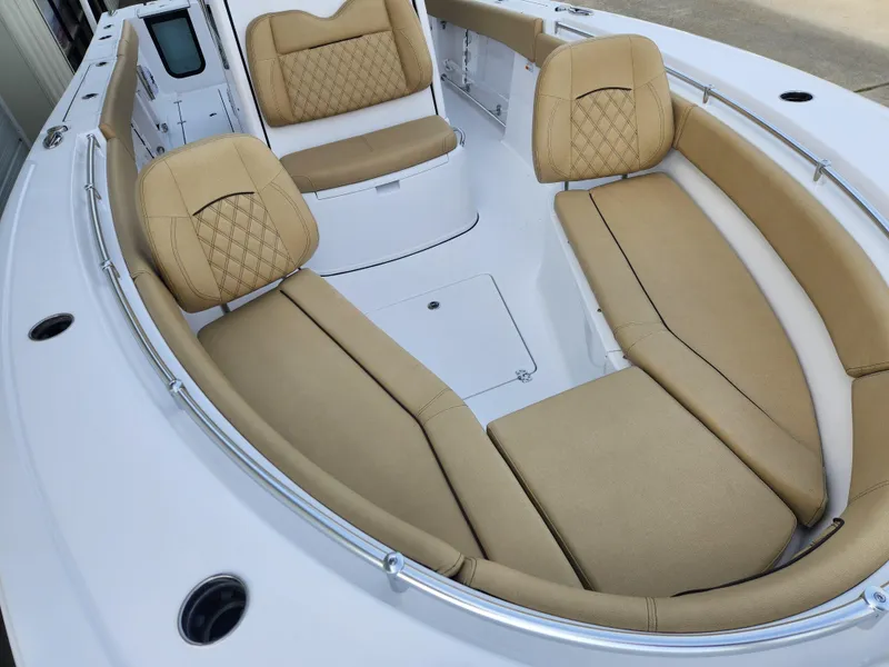 Slide: The Image of 2025 Sportsman Open 262 Center Console boat with tan cushioned seating and sleek design. - 11