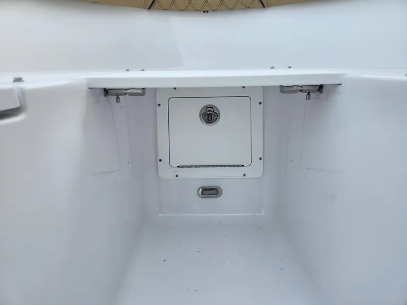 Slide: The Image of 2025 Sportsman Open 262 Center Console storage compartment, featuring a secure hatch and clean interior. - 14