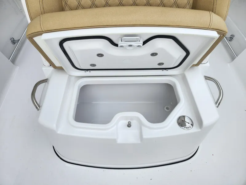 Slide: The Image of Open storage compartment on 2025 Sportsman Open 262 Center Console boat. - 16