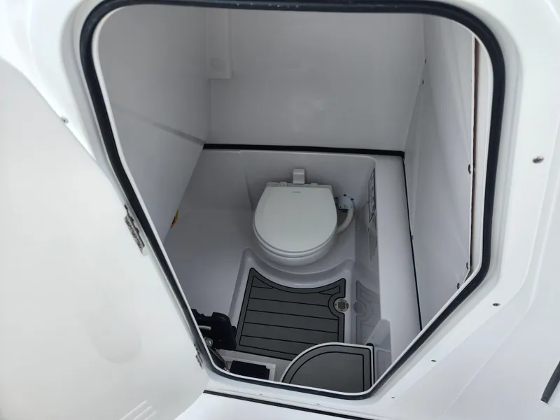 Slide: The Image of Interior of 2025 Sportsman Open 262 Center Console boat with compact marine toilet. - 17
