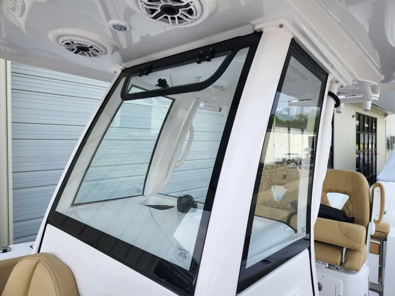 Slide: The Image of 2025 Sportsman Open 262 Center Console boat with sleek windshield and beige seating. - 20