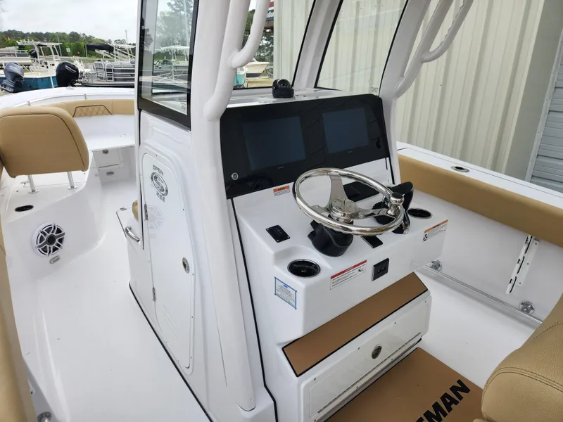 Slide: The Image of 2025 Sportsman Open 262 Center Console boat interior with dual screens and steering wheel. - 22