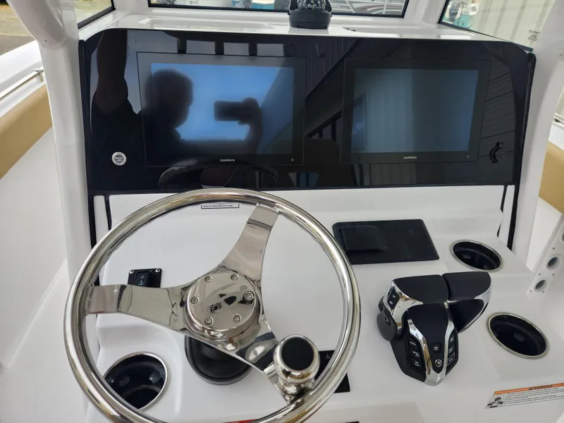 Slide: The Image of 2025 Sportsman Open 262 Center Console dashboard with dual screens and steering wheel. - 23