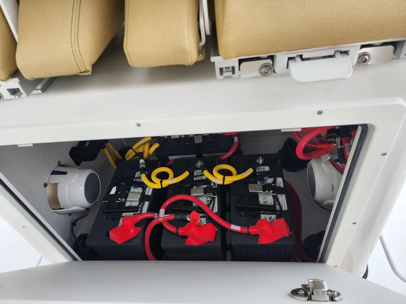 Slide: The Image of 2025 Sportsman Open 262 Center Console battery compartment with wiring and connections. - 28