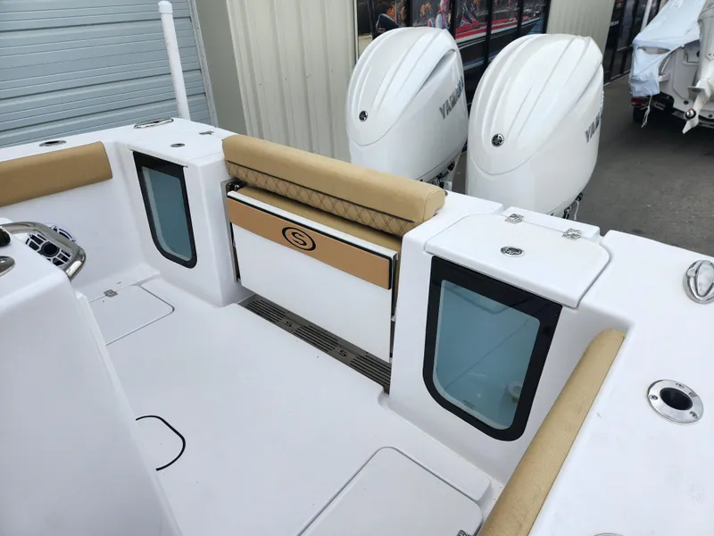 Slide: The Image of 2025 Sportsman Open 262 Center Console boat with dual Yamaha engines, beige seating, and storage compartments. - 29