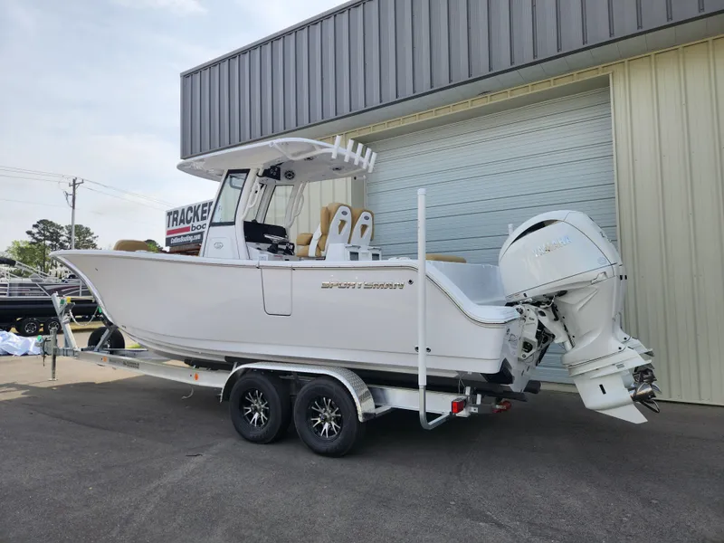 Slide: The Image of 2025 Sportsman Open 262 Center Console boat on trailer, parked outside a building. - 3