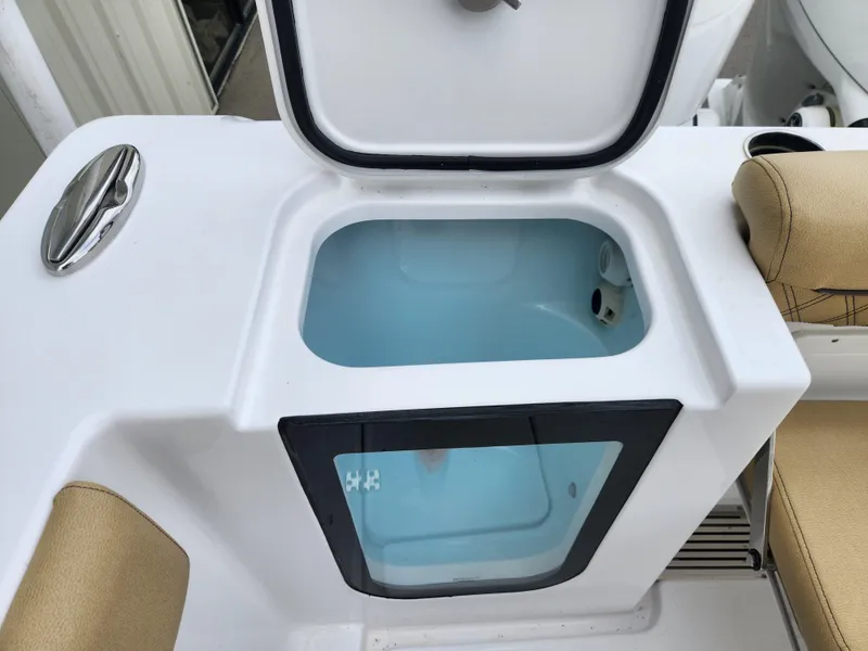Slide: The Image of 2025 Sportsman Open 262 Center Console livewell with open lid and cushioned seating. - 32