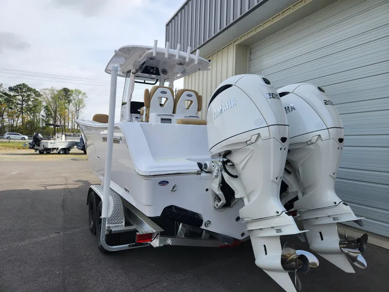 Slide: The Image of 2025 Sportsman Open 262 Center Console boat with dual Yamaha engines on a trailer. - 5