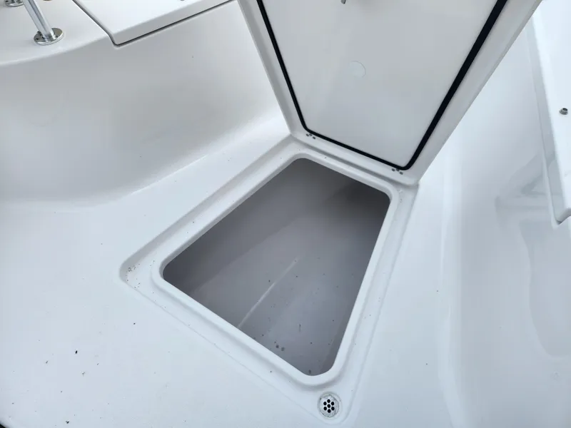 Slide: The Image of Open storage compartment on 2025 Sportsman Open 262 Center Console boat. - 9