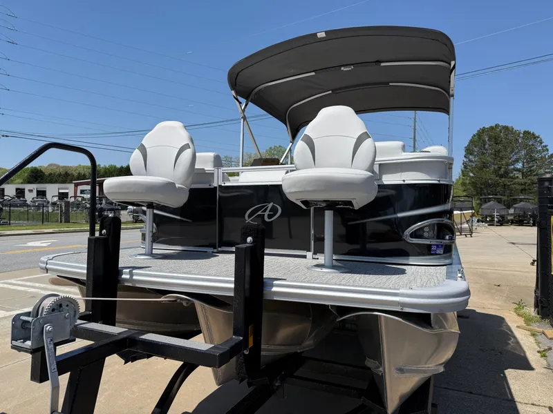 Slide: The Image of 2022 Avalon Venture Fish boat on trailer, featuring dual seats and canopy under clear sky. - 18
