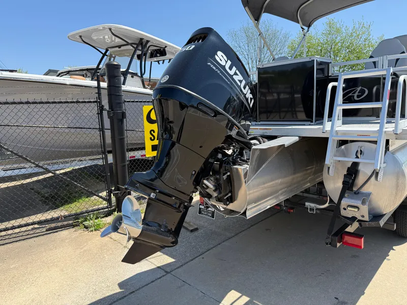 Slide: The Image of 2022 Avalon Venture Fish boat with Suzuki outboard motor, docked outdoors. - 20