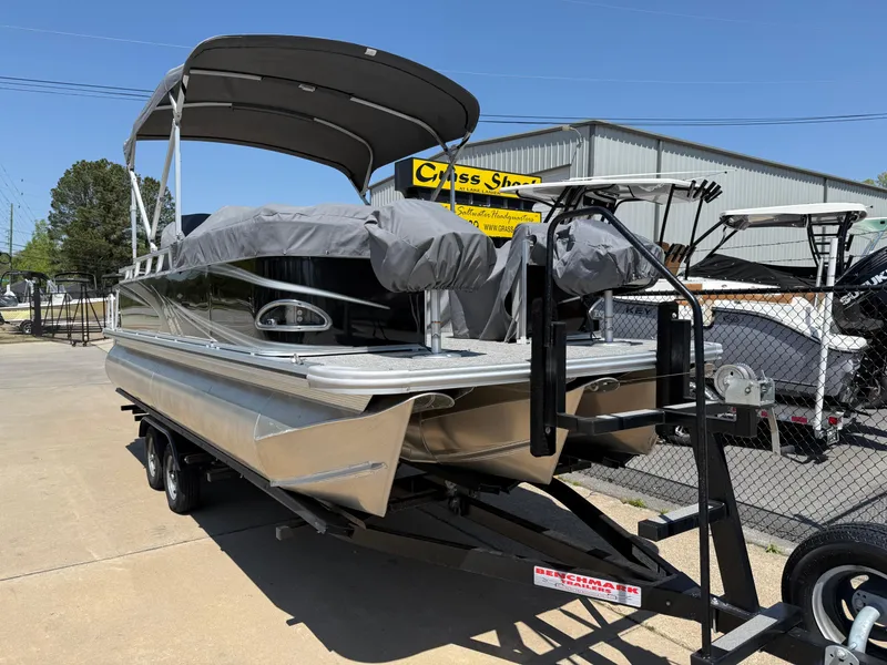 Slide: The Image of 2022 Avalon Venture Fish pontoon boat on trailer, covered and parked outdoors. - 25