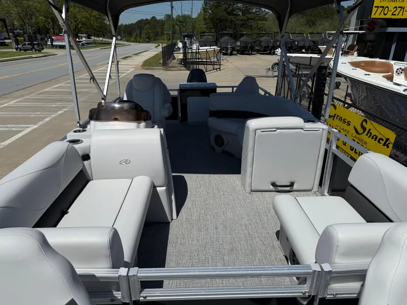Slide: The Image of 2022 Avalon Venture Fish pontoon boat with spacious seating and canopy, parked on a sunny day. - 29