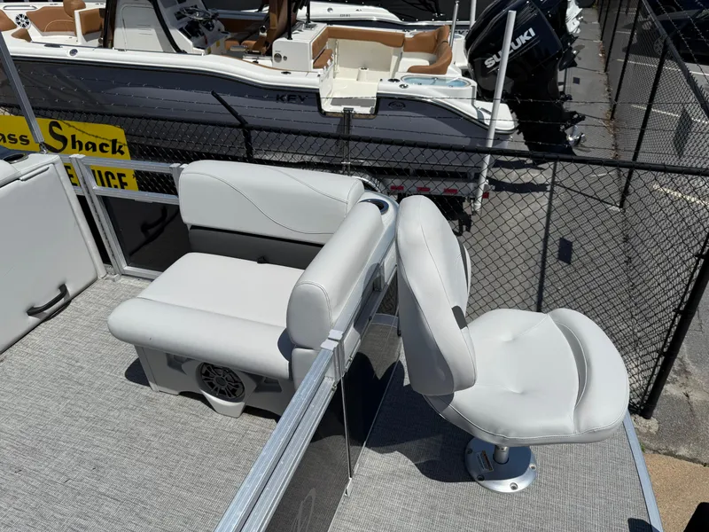 Slide: The Image of 2022 Avalon Venture Fish boat seats, gray upholstery, outdoor setting, near other boats. - 33