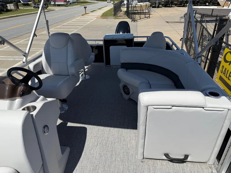Slide: The Image of 2022 Avalon Venture Fish pontoon boat interior with plush seating and steering console. - 35