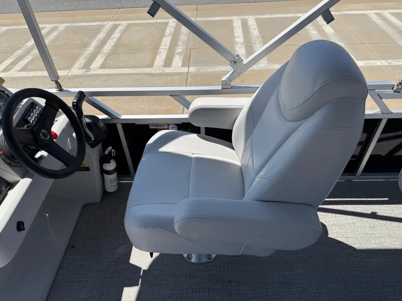 Slide: The Image of 2022 Avalon Venture Fish boat interior with a comfortable captain's chair and steering wheel. - 38