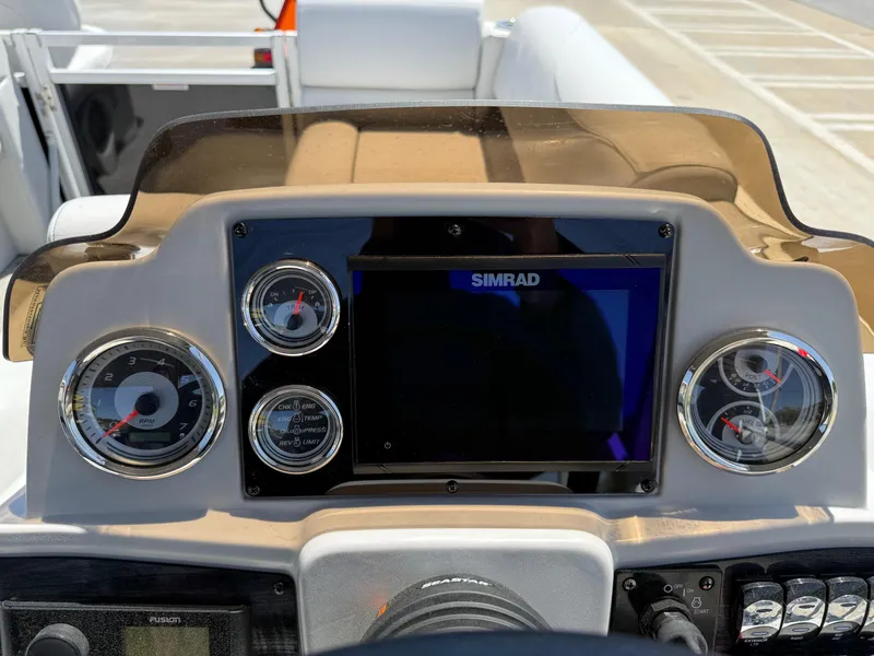 Slide: The Image of Dashboard of 2022 Avalon Venture Fish boat with gauges and Simrad display. - 42