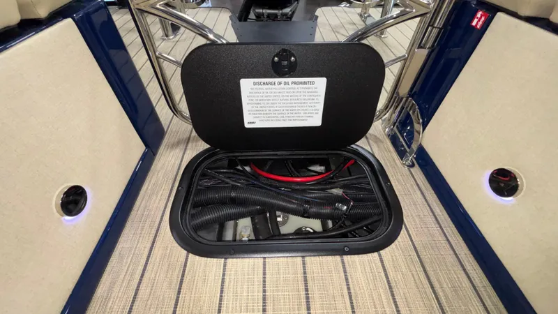 Slide: The Image of Open storage compartment on Balise Helix 26C boat, showcasing cables and wiring, 2025 model. - 14