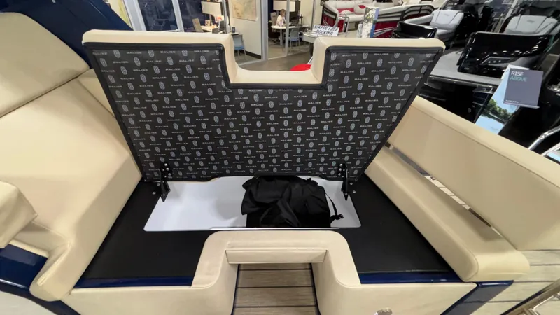 Slide: The Image of 2025 Balise Helix 26C boat interior with open storage compartment and beige seating. - 18