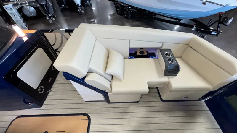 Slide: The Image of Luxurious seating area on 2025 Balise Helix 26C boat, featuring beige upholstery and cup holders. - 21