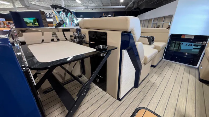 Slide: The Image of Luxurious interior of 2025 Balise Helix 26C boat with beige seating and sleek table design. - 25