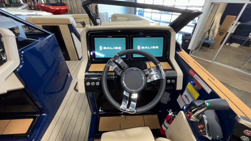 Slide: The Image of 2025 Balise Helix 26C boat cockpit with dual screens and modern steering wheel. - 28