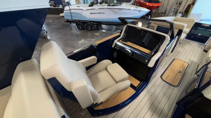 Slide: The Image of Luxurious interior of 2025 Balise Helix 26C boat with beige seating and sleek dashboard. - 8