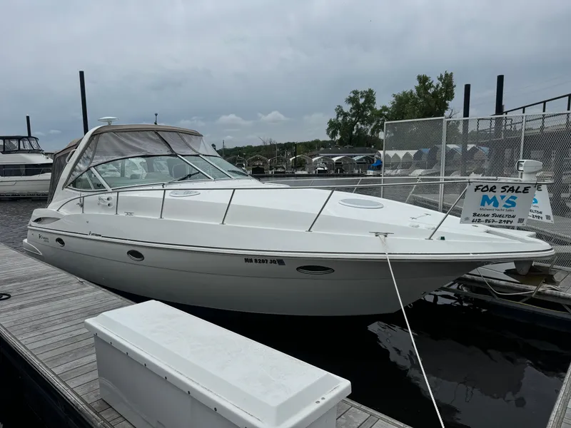 The Image of 2001 Cruisers Yachts 3470 Express docked, available for sale, with sleek white exterior. - 0