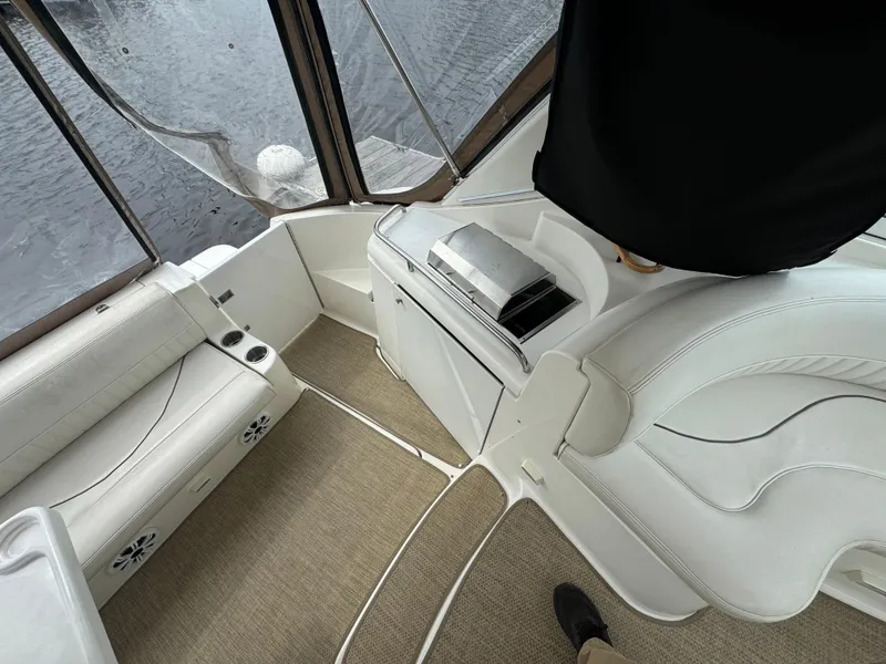Slide: The Image of 2001 Cruisers Yachts 3470 Express interior with white seating and carpeted flooring. - 18