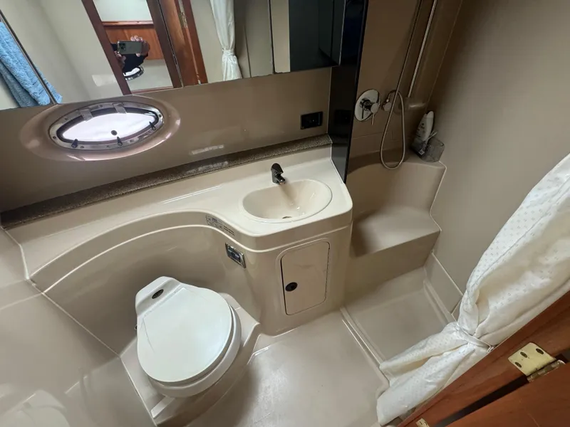 Slide: The Image of 2001 Cruisers Yachts 3470 Express bathroom with sink, toilet, and shower. - 7
