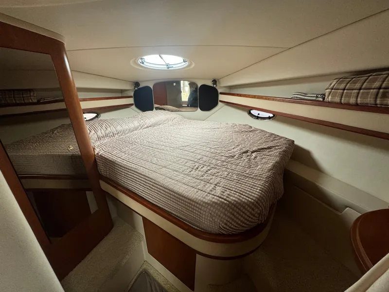 Slide: The Image of 2001 Cruisers Yachts 3470 Express cabin with bed and porthole window. - 8