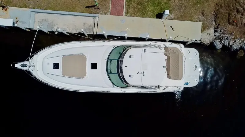 Slide: The Image of Top view of a 2001 Sea Ray 460 Sundancer docked at a pier. - 1