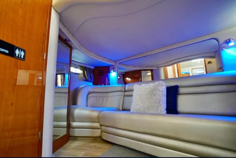 Slide: The Image of Luxurious interior of 2001 Sea Ray 460 Sundancer yacht with plush seating and ambient lighting. - 13