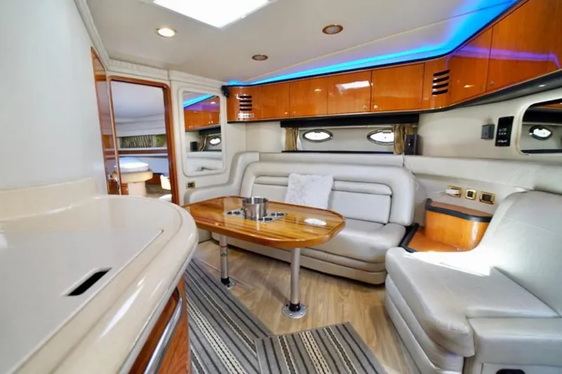 Slide: The Image of Luxurious interior of 2001 Sea Ray 460 Sundancer yacht with elegant seating and ambient lighting. - 14