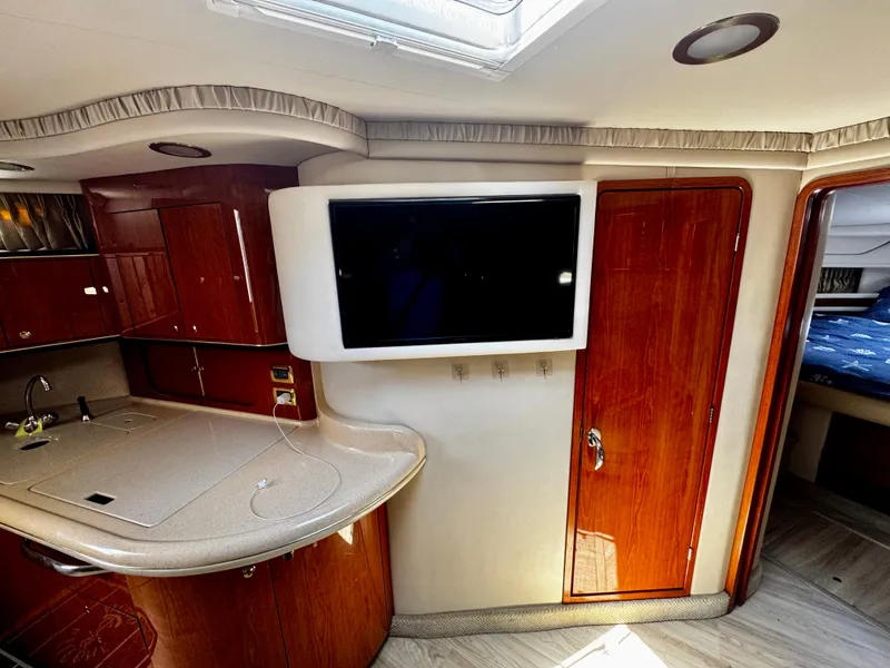 Slide: The Image of Interior of 2001 Sea Ray 460 Sundancer yacht with modern kitchen and TV. - 16