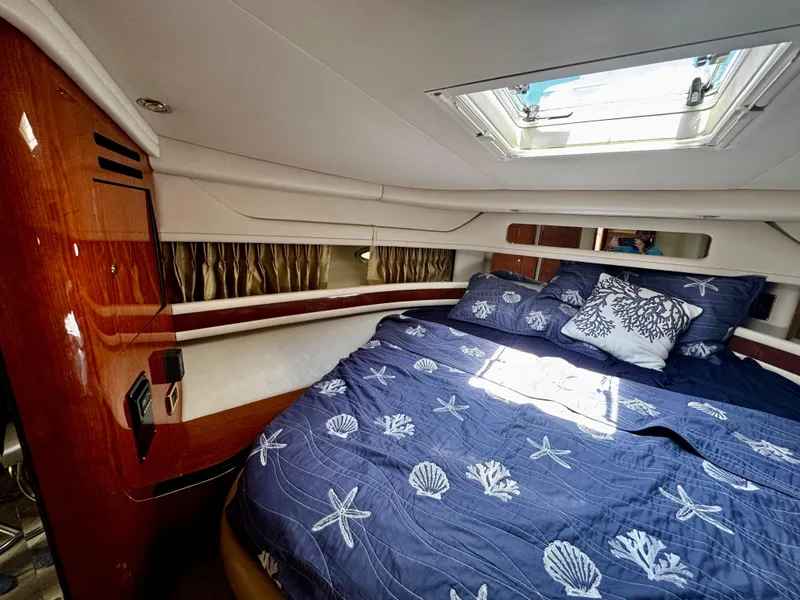 Slide: The Image of Luxurious cabin interior of 2001 Sea Ray 460 Sundancer with nautical-themed bedding. - 20
