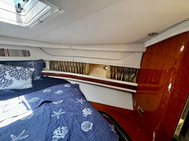 Slide: The Image of Luxurious cabin interior of 2001 Sea Ray 460 Sundancer yacht with nautical-themed bedding. - 22