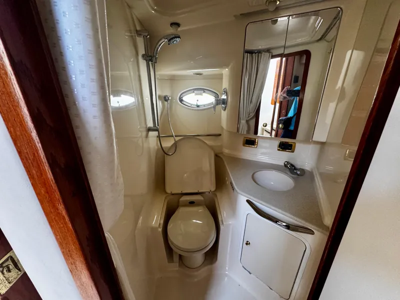 Slide: The Image of Bathroom interior of 2001 Sea Ray 460 Sundancer yacht, featuring shower, toilet, and sink. - 23