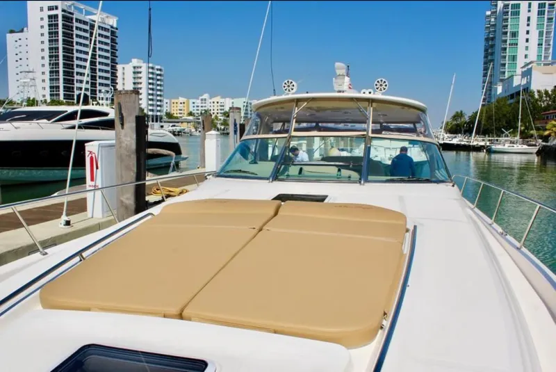 Slide: The Image of 2001 Sea Ray 460 Sundancer yacht docked in a marina with cityscape background. - 26