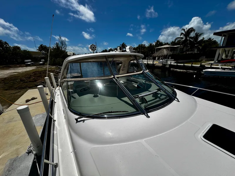 Slide: The Image of 2001 Sea Ray 460 Sundancer docked, showcasing sleek design under a clear blue sky. - 29