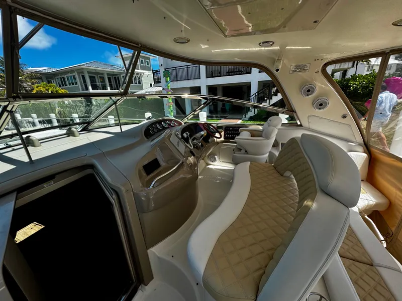 Slide: The Image of Interior view of a 2001 Sea Ray 460 Sundancer yacht with luxurious seating and helm. - 3
