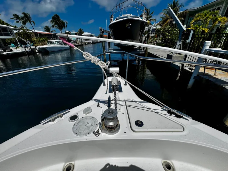Slide: The Image of Bow view of 2001 Sea Ray 460 Sundancer docked in a sunny marina. - 31