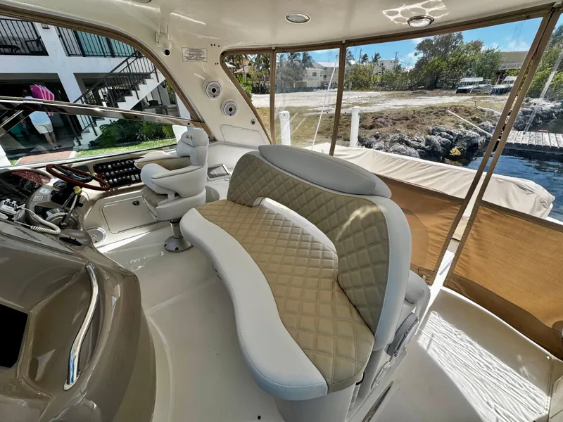 Slide: The Image of Luxurious interior of 2001 Sea Ray 460 Sundancer yacht with plush seating and helm station. - 4