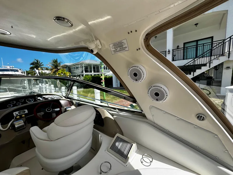 Slide: The Image of Interior view of 2001 Sea Ray 460 Sundancer yacht, featuring helm and luxurious seating. - 6